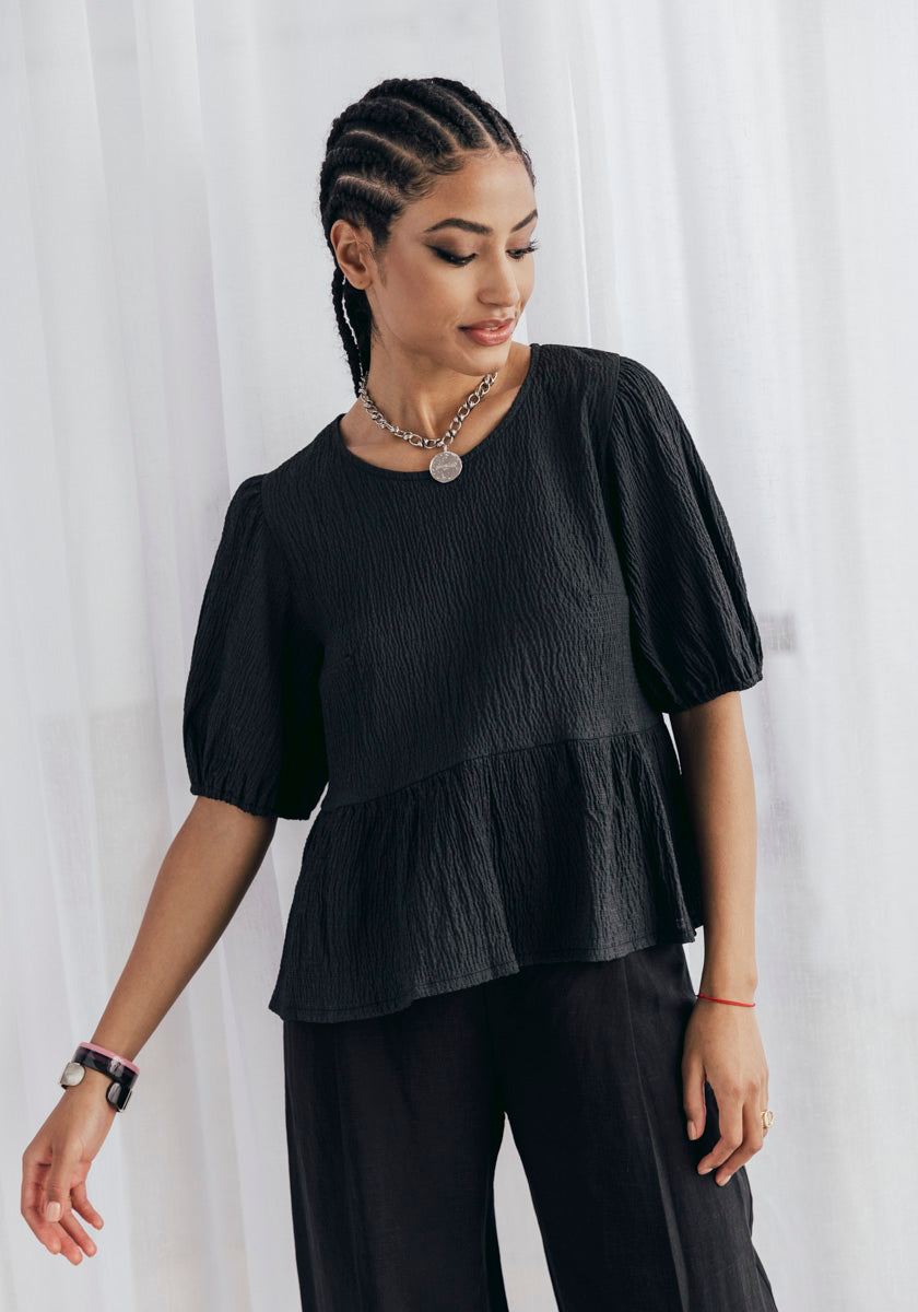 Top femme noir coupe peplum manches courtes